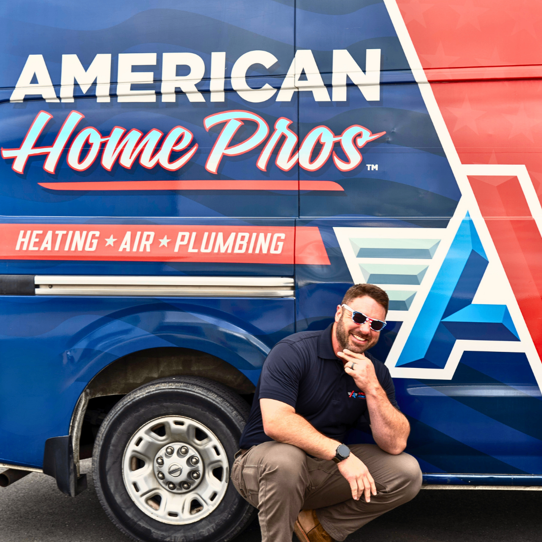 American Home Pros team member posing beside branded service van