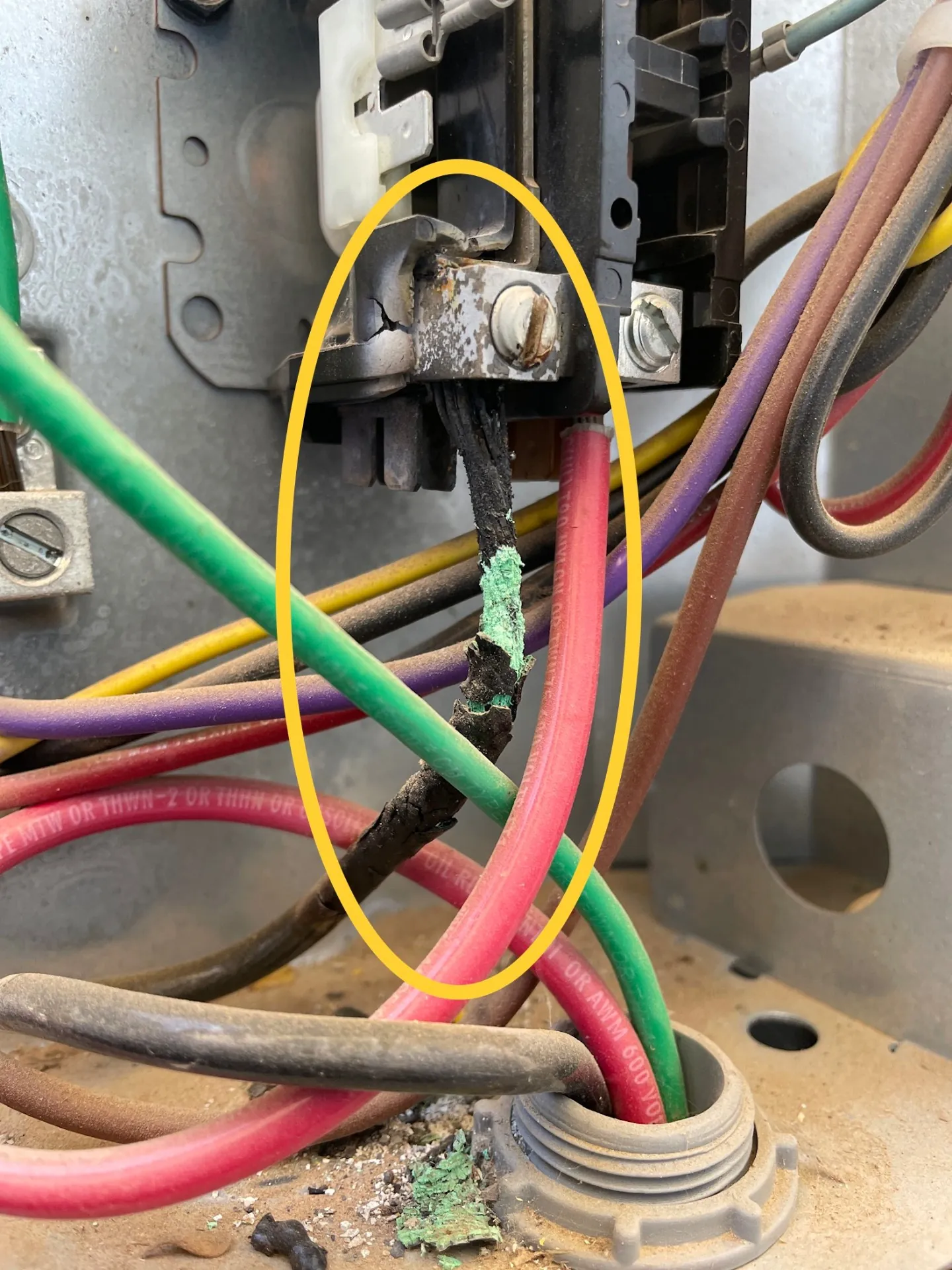 Burned low-voltage wire inside HVAC equipment highlighted for repair