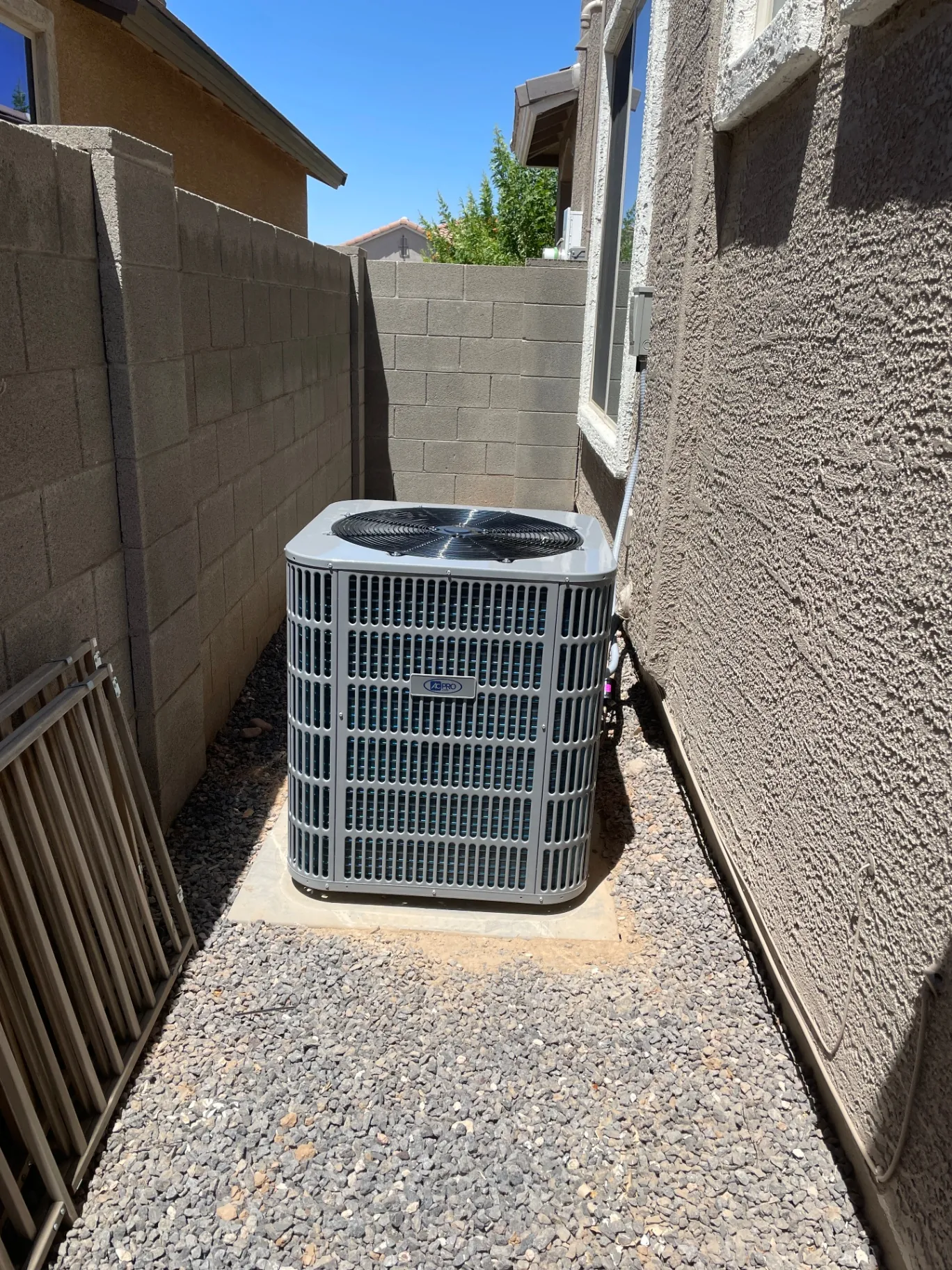 Outdoor AC Pro condenser installed beside a home