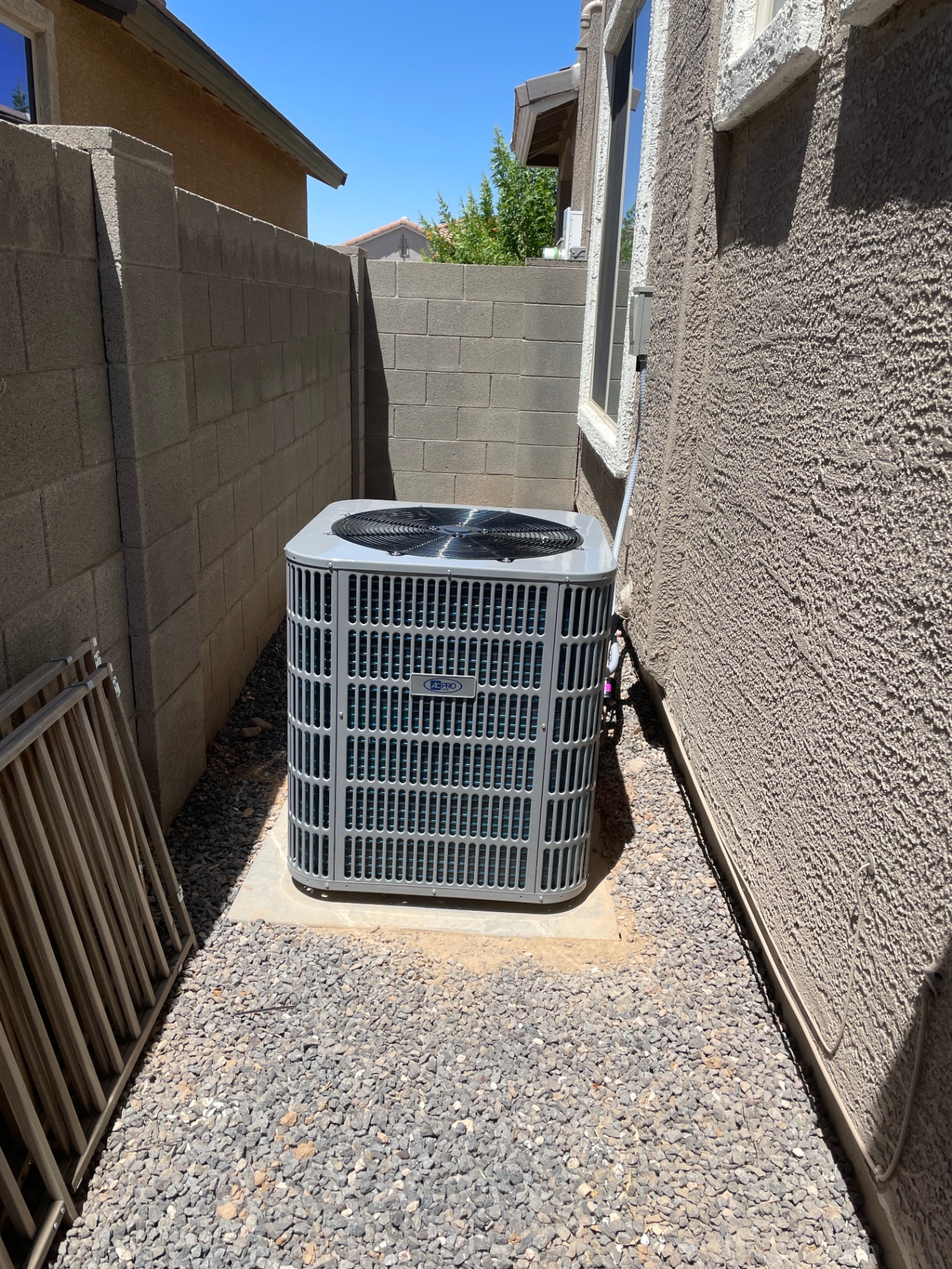 Outdoor AC Pro condenser installed beside a home