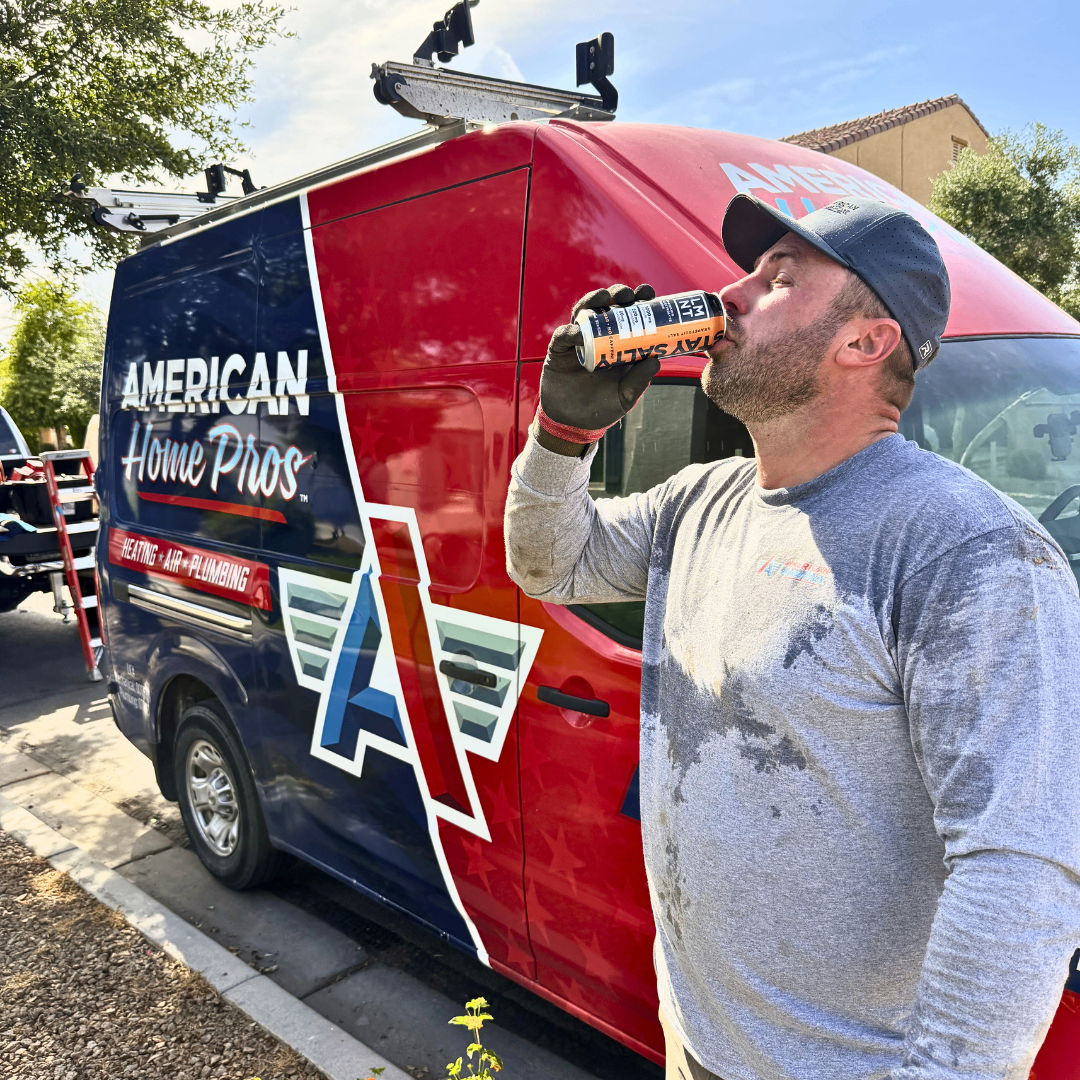 American Home Pros technician beside branded van during a workday