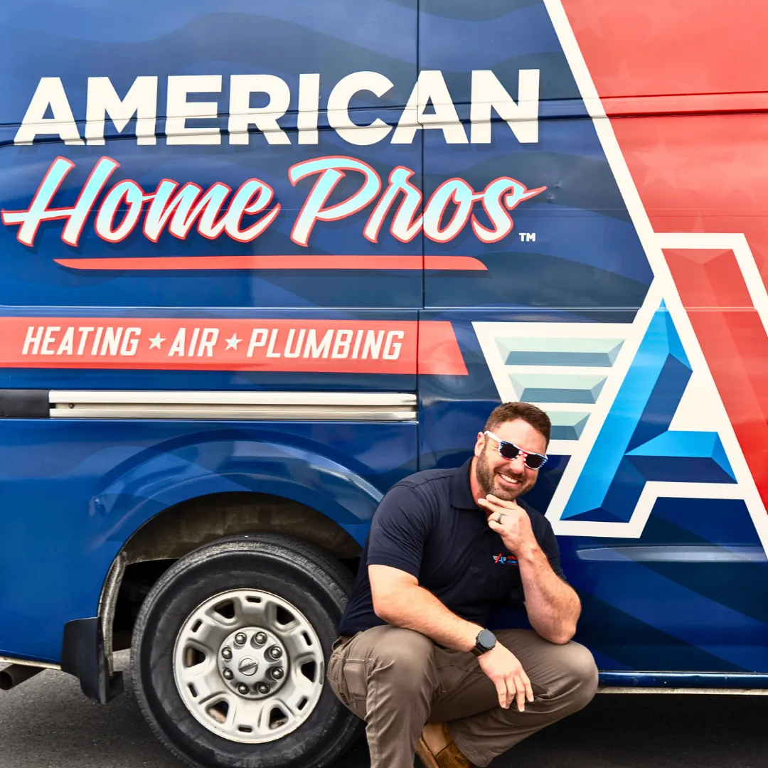 American Home Pros team member posing beside branded service van