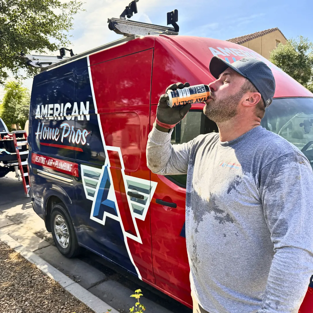 American Home Pros technician beside branded van during a workday