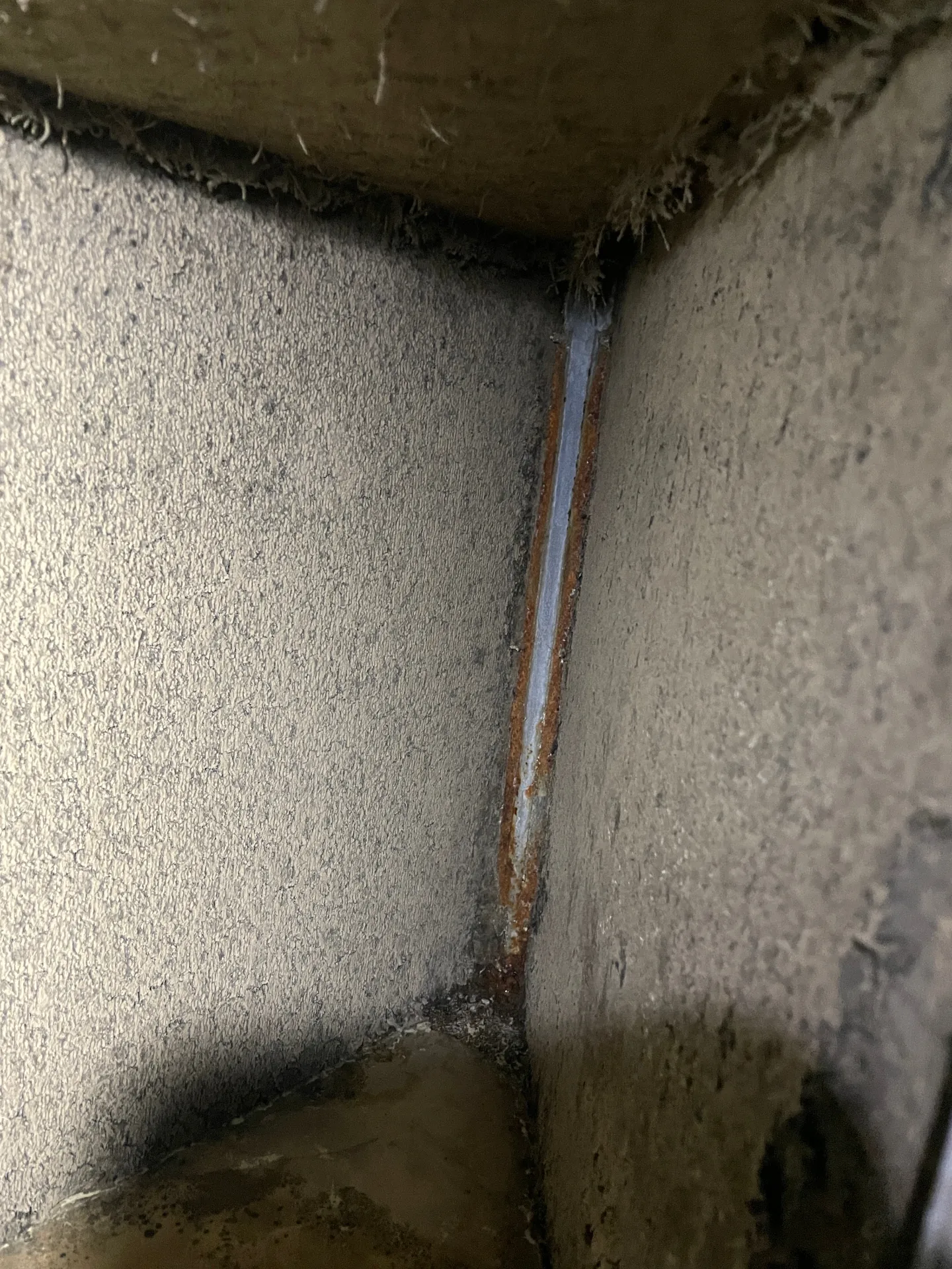 Rusted drain pan and standing water inside HVAC equipment
