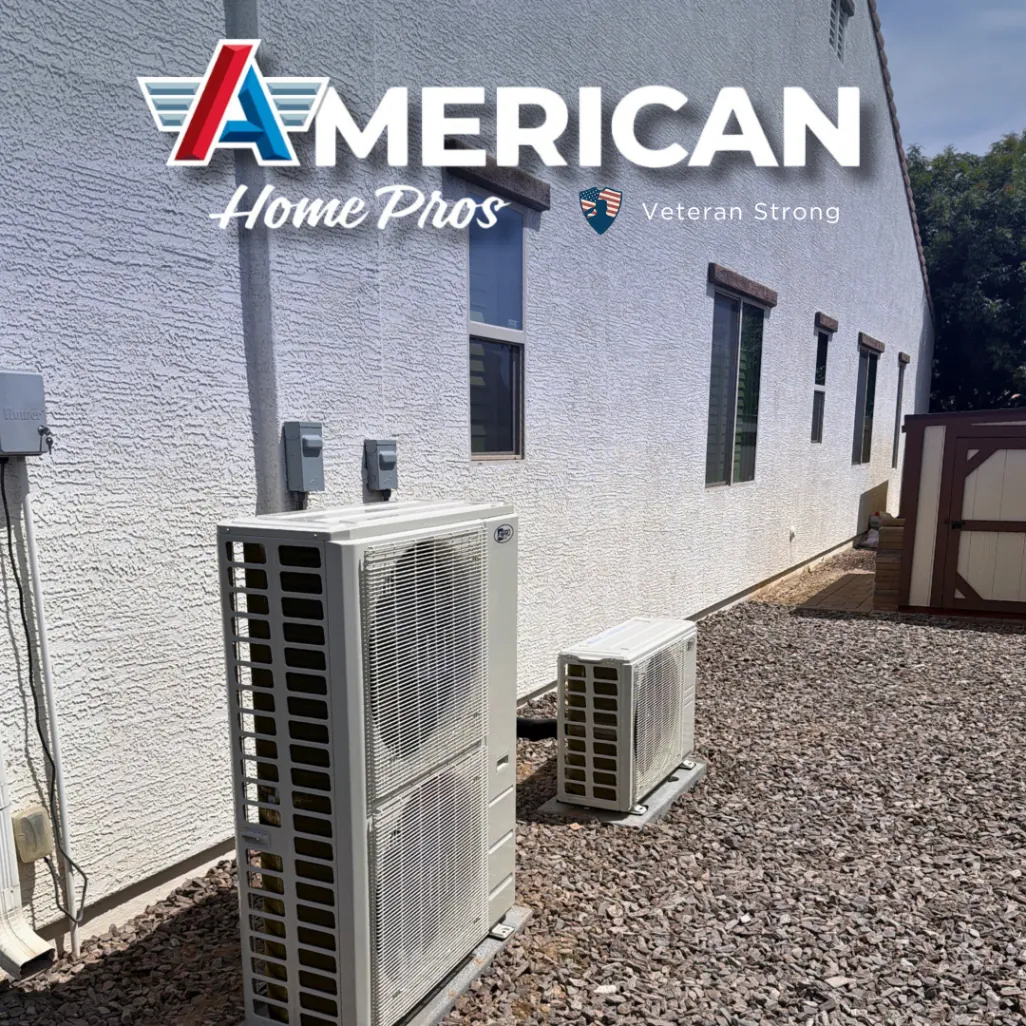 Two outdoor mini-split condensers installed along a home exterior wall